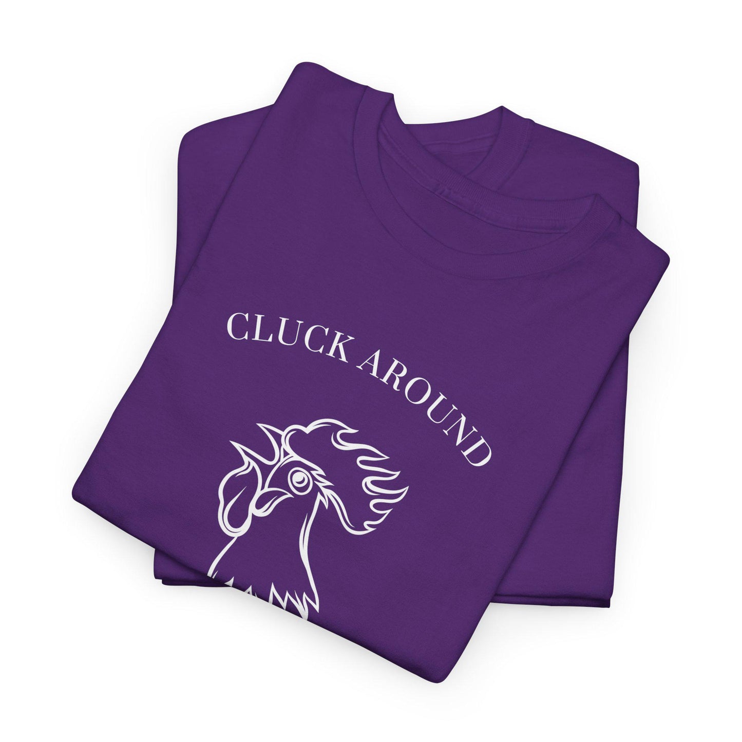 Two neatly folded purple t-shirts are stacked, with the top shirt displaying a white graphic of a rooster’s head. Above the rooster is the text “CLUCK AROUND,” partially visible due to the fold. The shirts have a crew neckline and are arranged on a plain white surface, emphasizing the bold design and vibrant color.