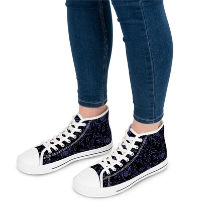 Navy floral high-top sneakers with white laces worn with blue jeans on a white background