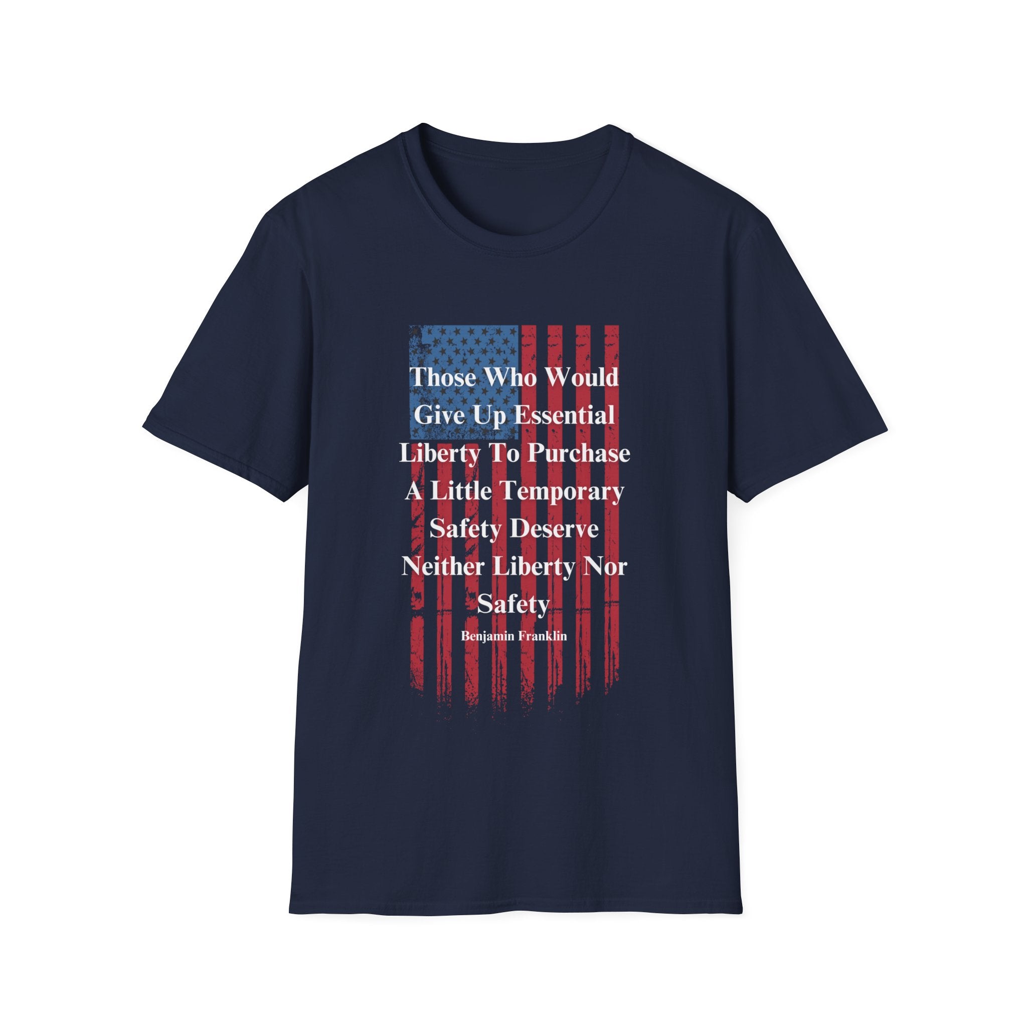 A navy blue T-shirt is displayed against a white background, featuring a distressed vertical American flag graphic in red and blue. Overlaid on the flag is a bold white quote by Benjamin Franklin that reads: “Those who would give up essential liberty to purchase a little temporary safety deserve neither liberty nor safety.” The design emphasizes patriotic values and freedom in a bold, minimalist style.