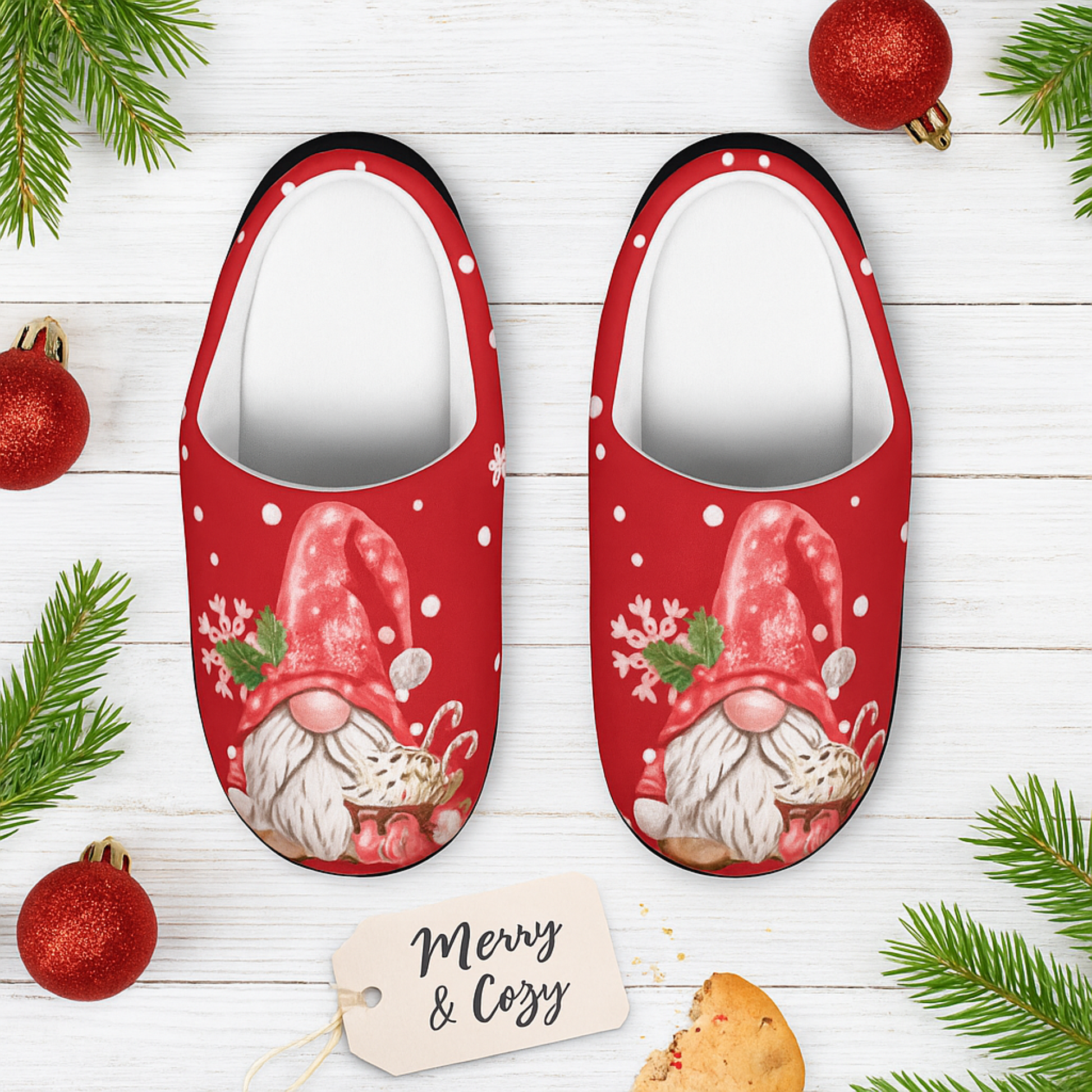 Red slippers with Santa gnome design on a wooden surface with Christmas decorations.