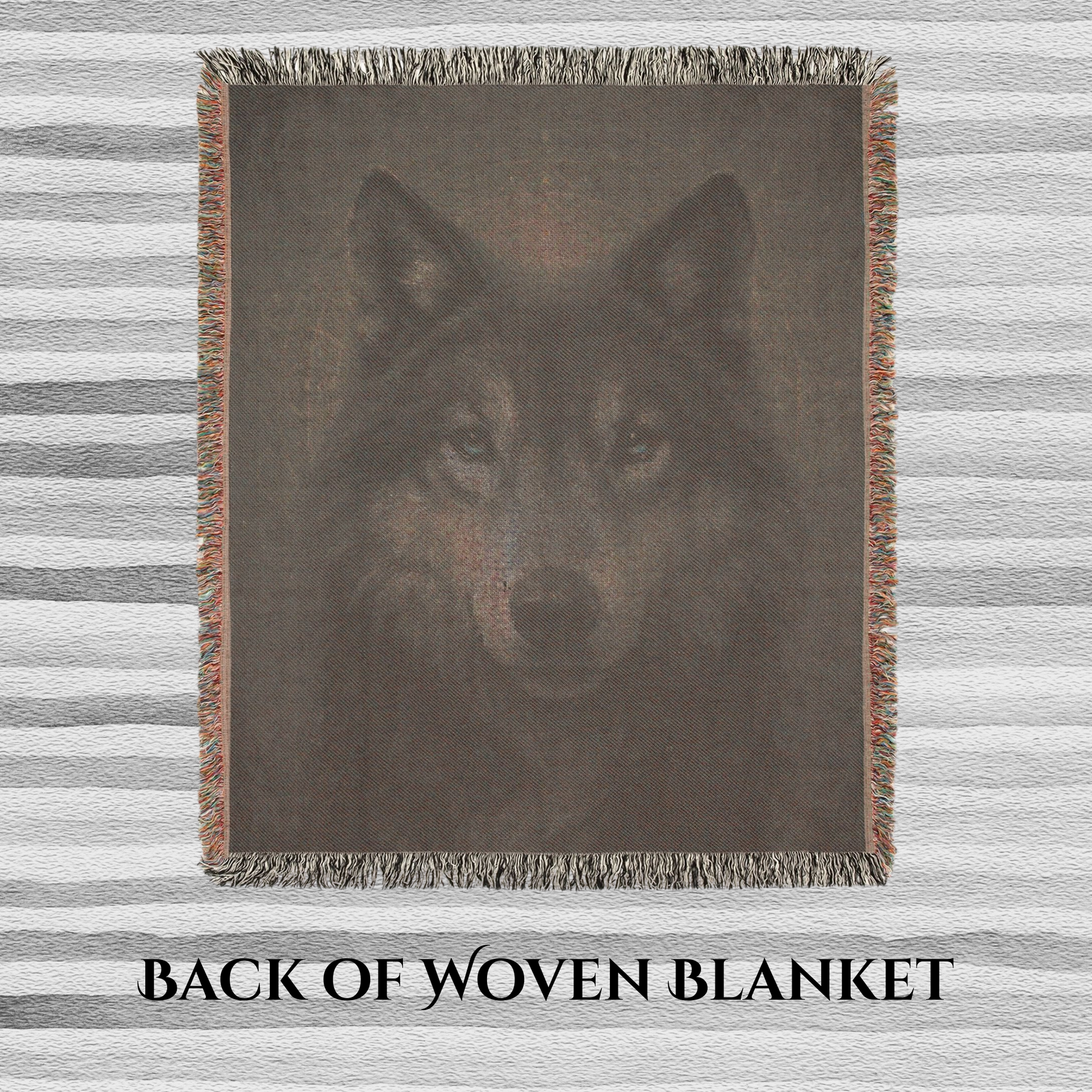 Back view of woven blanket with a wolf design on a striped background
