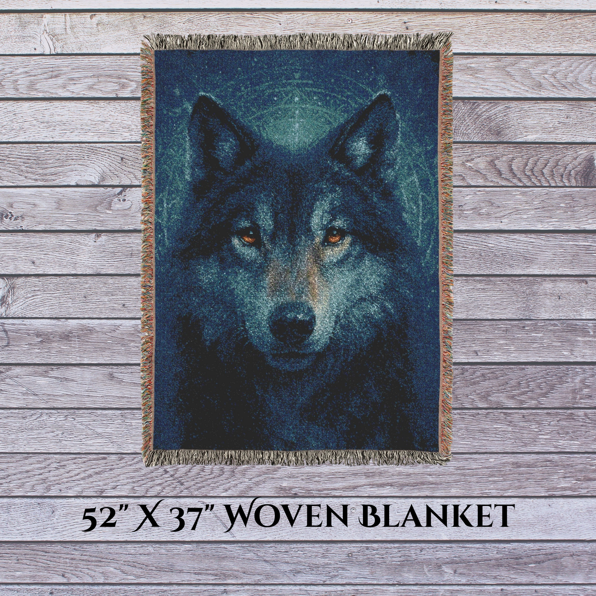 Woven blanket with a wolf design on a wooden surface