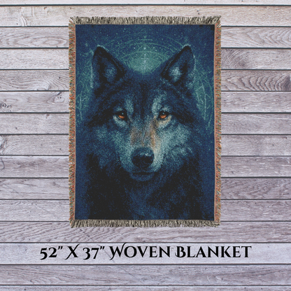 Woven blanket with a wolf design on a wooden surface