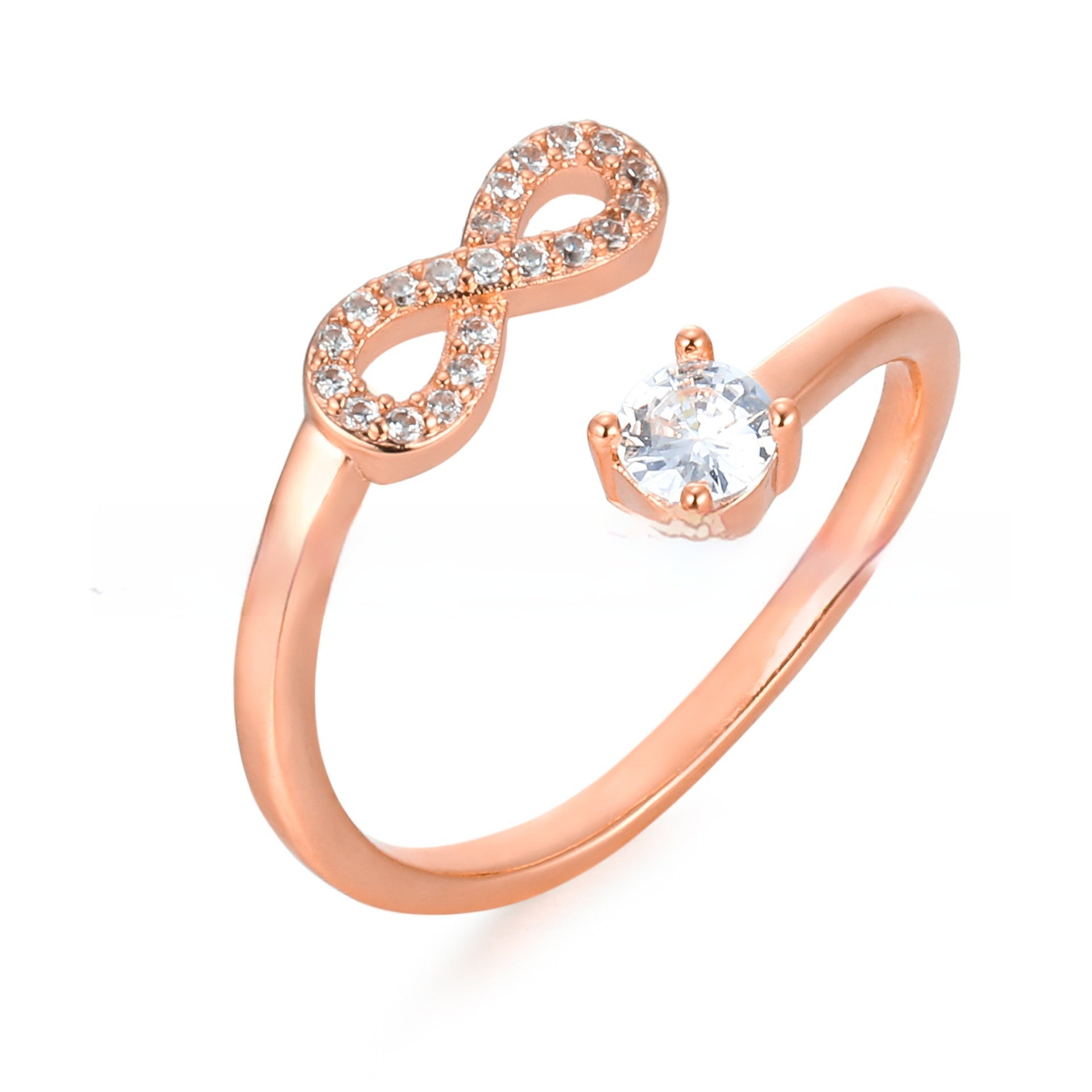 Rose gold ring with infinity symbol and clear gemstone on a white background