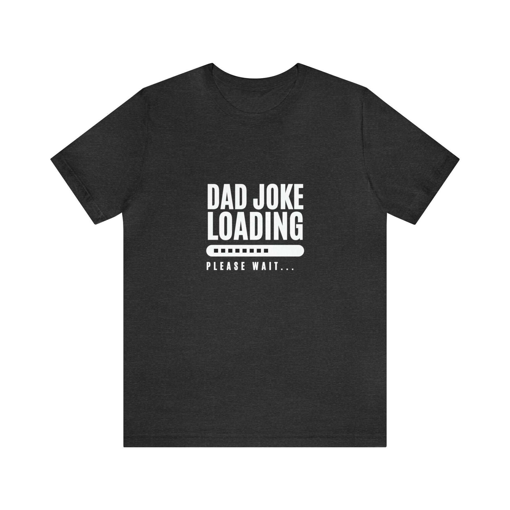 Dark heather gray unisex T-shirt featuring the humorous phrase “Dad Joke Loading, Please Wait…” in bold white letters with a progress bar graphic centered on the front.