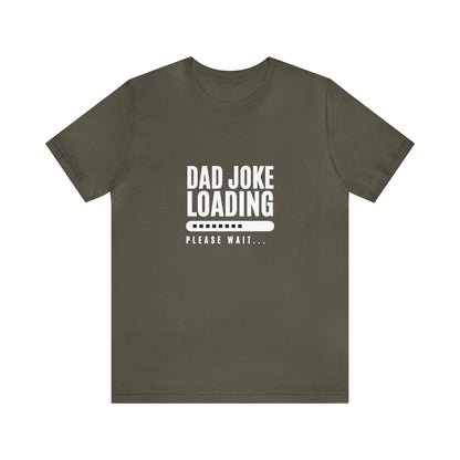 Olive green unisex T-shirt with the humorous phrase “Dad Joke Loading, Please Wait…” printed in bold white letters alongside a loading bar graphic in the center.