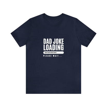 Navy blue unisex T-shirt with the funny phrase “Dad Joke Loading, Please Wait…” printed in bold white letters, accompanied by a progress bar graphic centered on the chest.