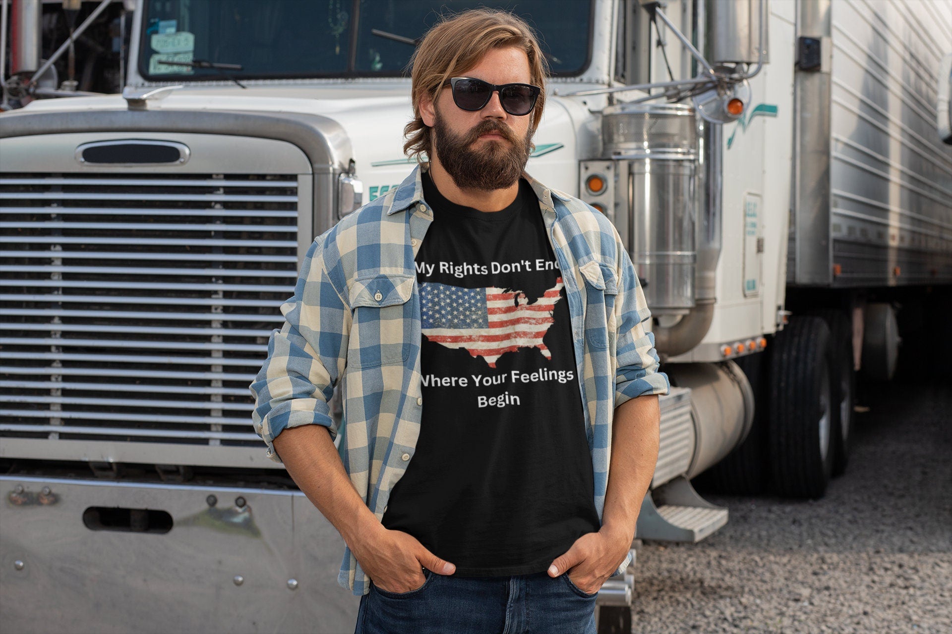 Men’s patriotic trucker t-shirt featuring a distressed American flag in the shape of the USA with the bold statement “My Rights Don’t End Where Your Feelings Begin” — perfect for truck drivers, freedom lovers, and pro-constitution apparel fans. Modeled by a bearded man in sunglasses and a flannel shirt, standing in front of a semi-truck.
