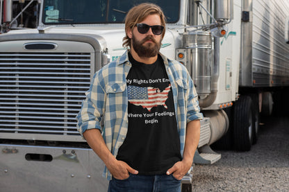 Men’s patriotic trucker t-shirt featuring a distressed American flag in the shape of the USA with the bold statement “My Rights Don’t End Where Your Feelings Begin” — perfect for truck drivers, freedom lovers, and pro-constitution apparel fans. Modeled by a bearded man in sunglasses and a flannel shirt, standing in front of a semi-truck.
