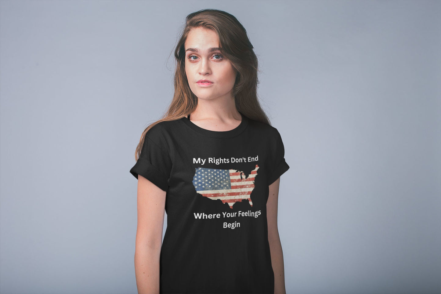 Unisex patriotic graphic t-shirt featuring a vintage American flag in the shape of the USA with the bold freedom quote &quot;My Rights Don&#39;t End Where Your Feelings Begin&quot; — ideal for conservative women, pro-constitution supporters, and American pride outfits. Modeled by a confident woman against a light background.