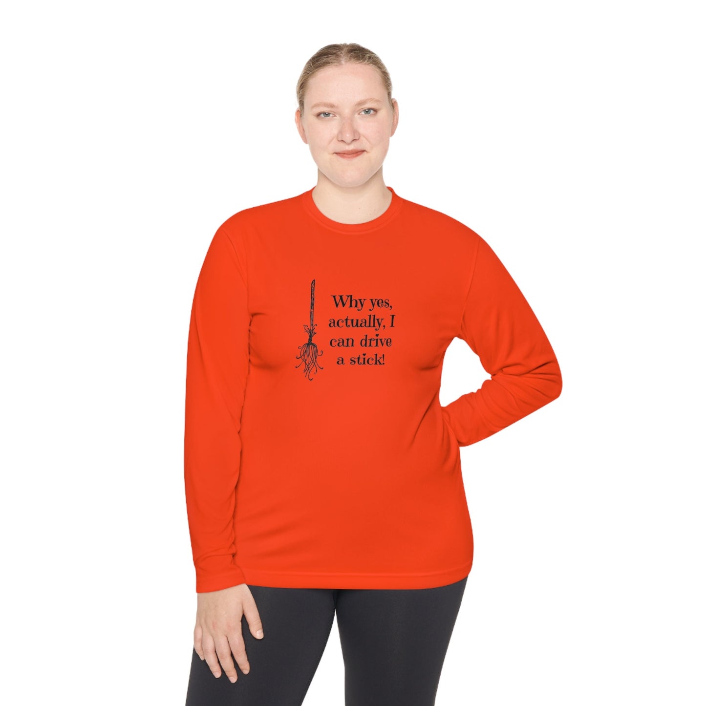 Woman wearing a bold orange long-sleeve Halloween shirt featuring a black broomstick illustration and the playful witch quote &quot;Why yes, actually, I can drive a stick!&quot; — ideal for spooky season fashion, Halloween parties, and fall festivities. Funny witch-themed shirt for women, perfect for October outfits, costume alternatives, and autumn lovers.
