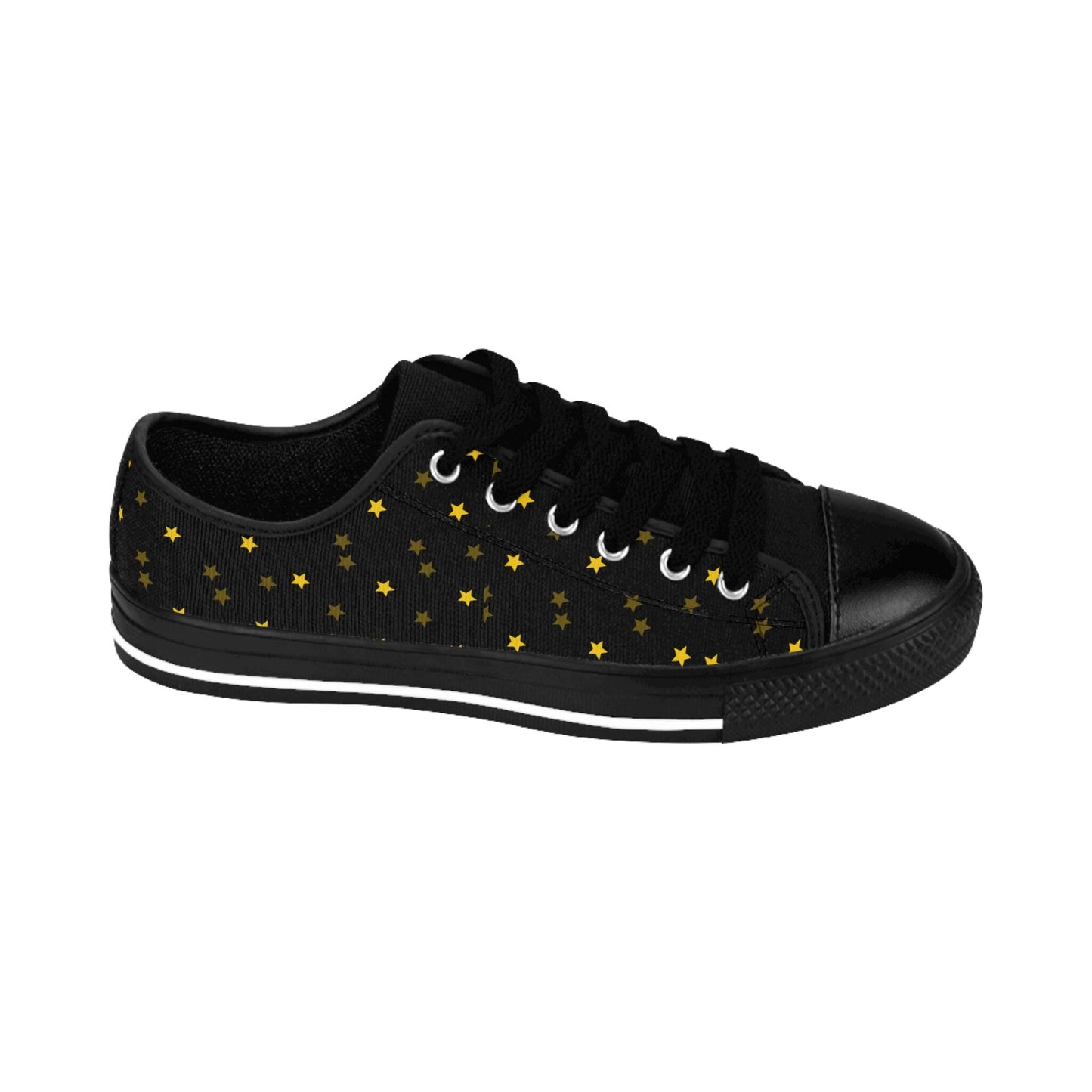 A single black low-top sneaker is shown in a side profile against a white background. The shoe features black laces, a black rubber toe cap, and a black sole with a white stripe. Its canvas upper is decorated with a scattered pattern of small gold stars, giving it a whimsical, starry-night look.