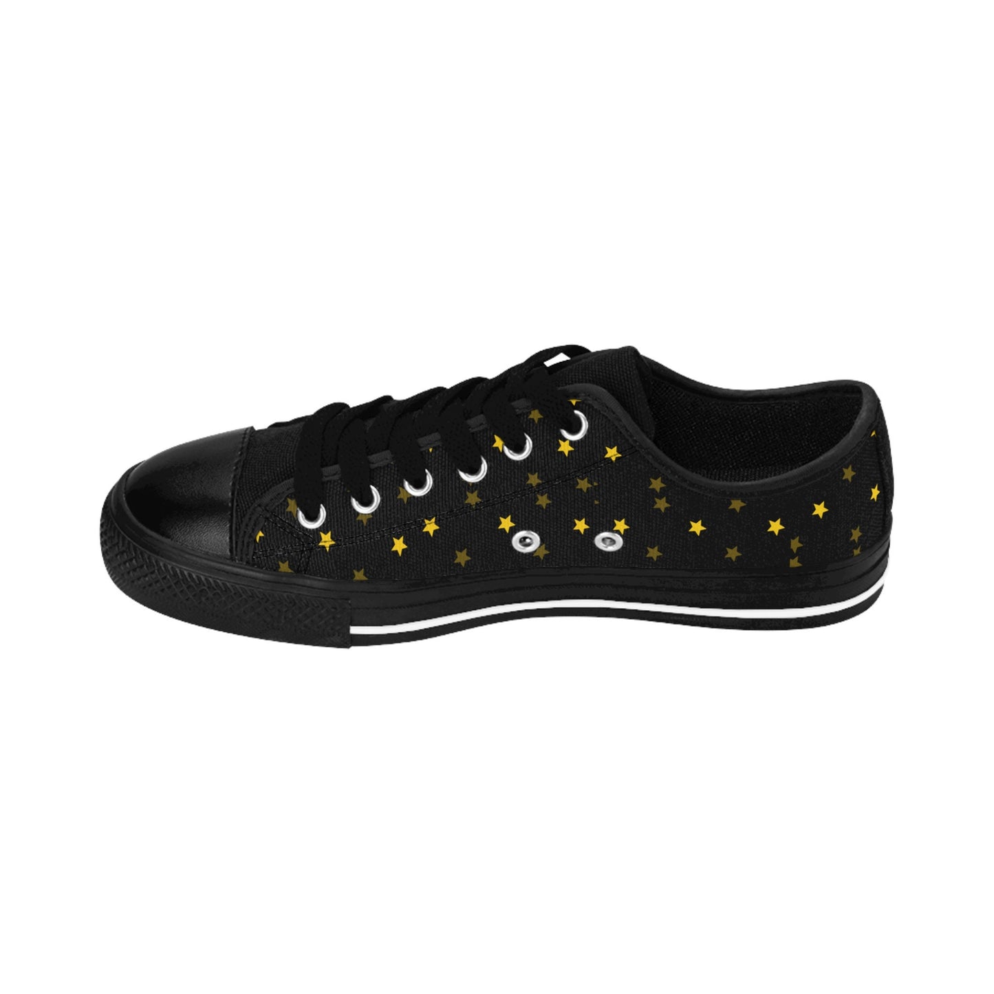 A single black low-top sneaker is displayed in a side view against a white background. The shoe features black laces, a black rubber toe cap, and a black sole with a white stripe. The canvas upper is decorated with a scattered pattern of small golden-yellow stars, creating a celestial, starry-night aesthetic.