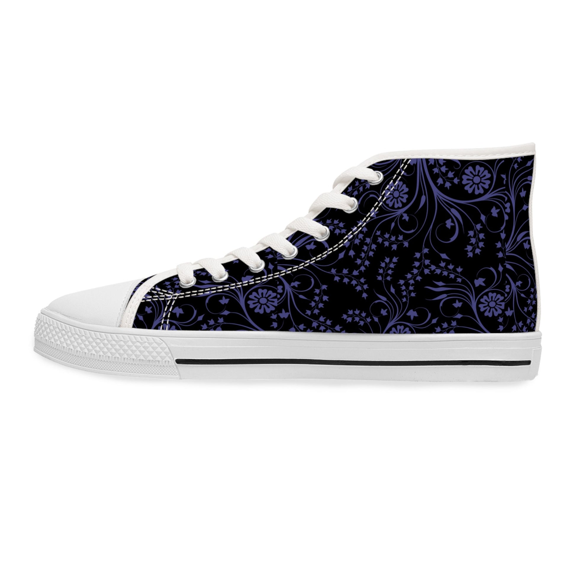 A single high-top sneaker is shown in a side view against a white background. The shoe features a black canvas upper decorated with a detailed purple floral and paisley pattern. It has white laces, a white rubber toe cap, and a white sole with a black stripe, giving it a bold and stylish contrast.