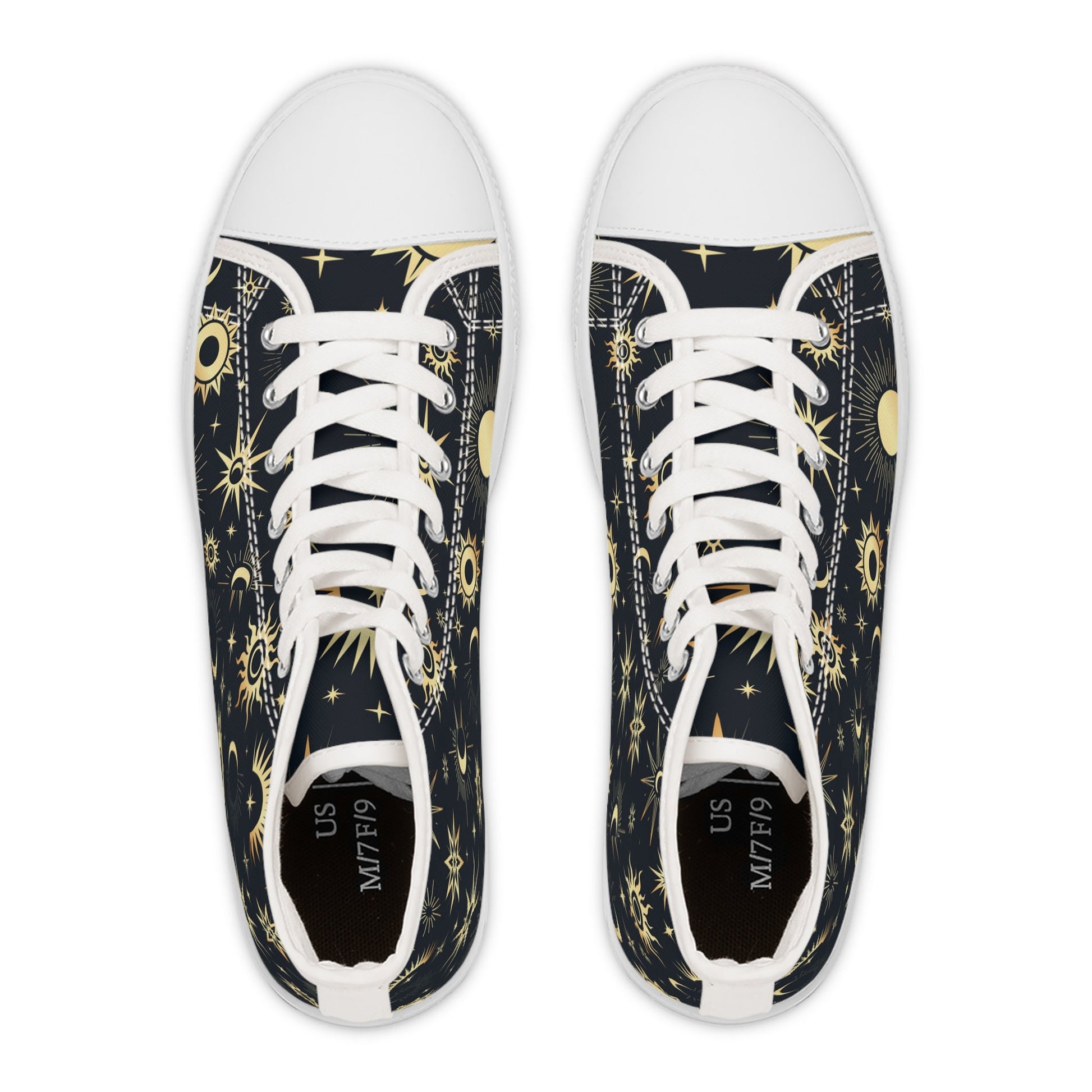 Top-down view of a pair of high-top sneakers with a celestial design featuring golden suns, moons, and stars on a dark navy background. The shoes have white laces, white rubber toe caps, and black insoles labeled with the size “US M7/F9.” The symmetrical pattern creates a visually striking cosmic aesthetic.