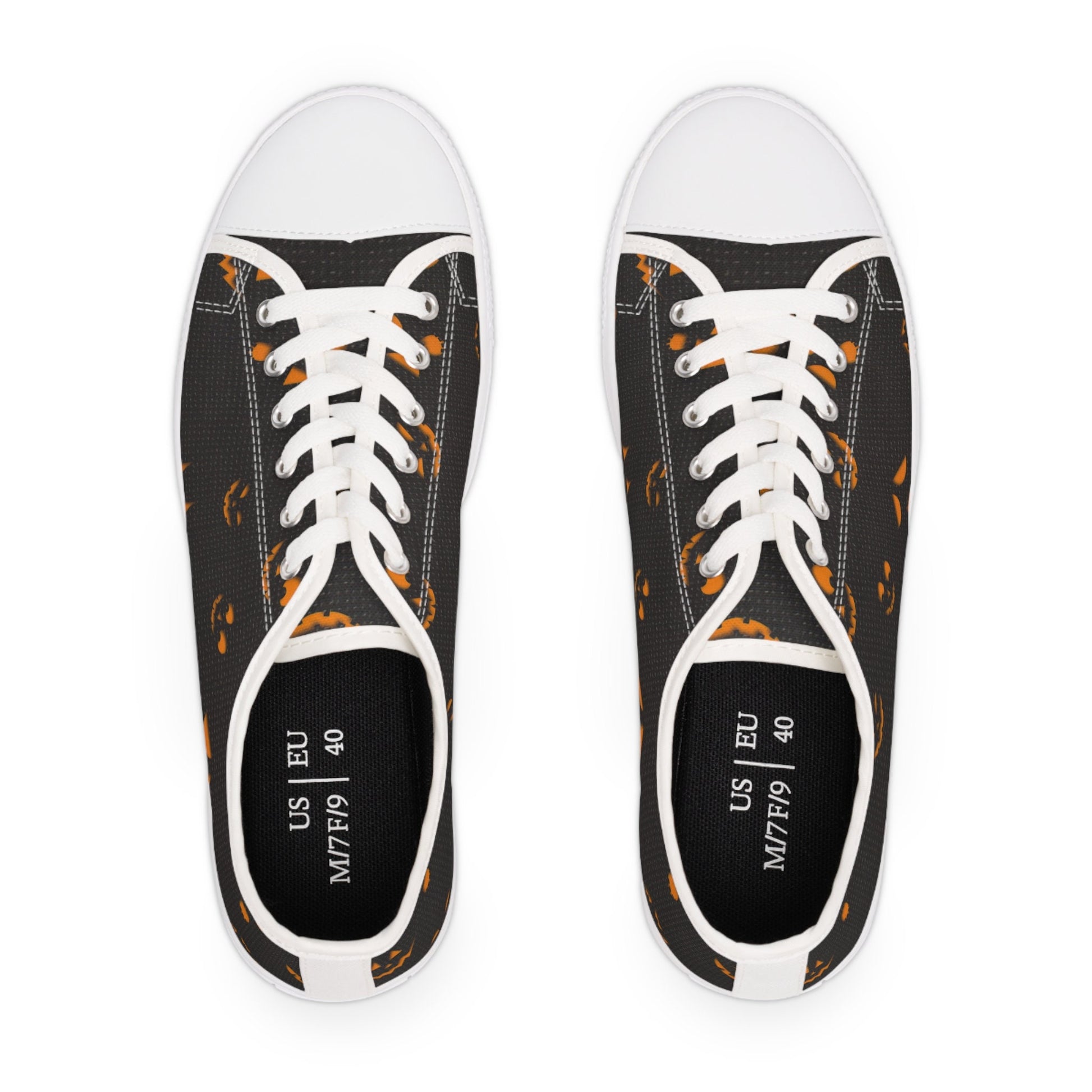 Top view of Halloween-themed canvas sneakers featuring orange jack-o&#39;-lantern face pattern on a black background with white laces and rubber toe caps – unisex US size 9 / EU 40 low-top shoes, perfect for spooky season outfits, Halloween events, and autumn fashion.