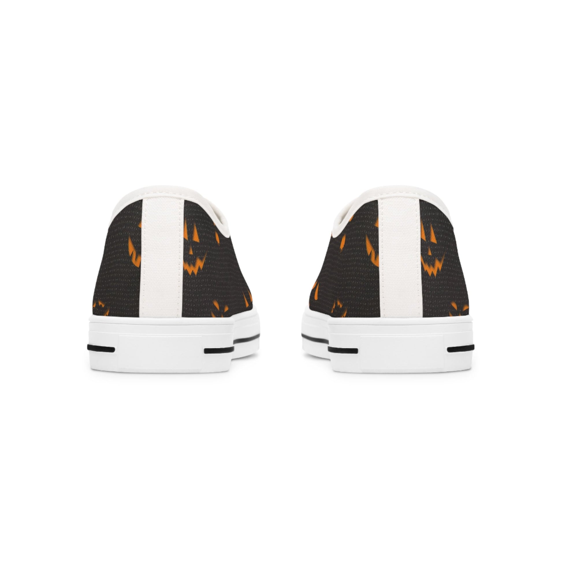 Back view of Halloween low-top canvas sneakers featuring a spooky orange jack-o&#39;-lantern face print on black fabric with white heel accents and white rubber soles – festive fall shoes perfect for Halloween outfits, trick-or-treat events, and spooky season fashion.