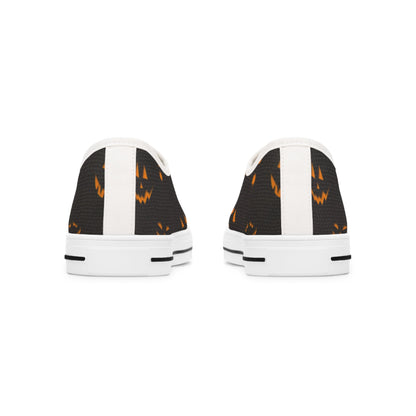 Back view of Halloween low-top canvas sneakers featuring a spooky orange jack-o&#39;-lantern face print on black fabric with white heel accents and white rubber soles – festive fall shoes perfect for Halloween outfits, trick-or-treat events, and spooky season fashion.