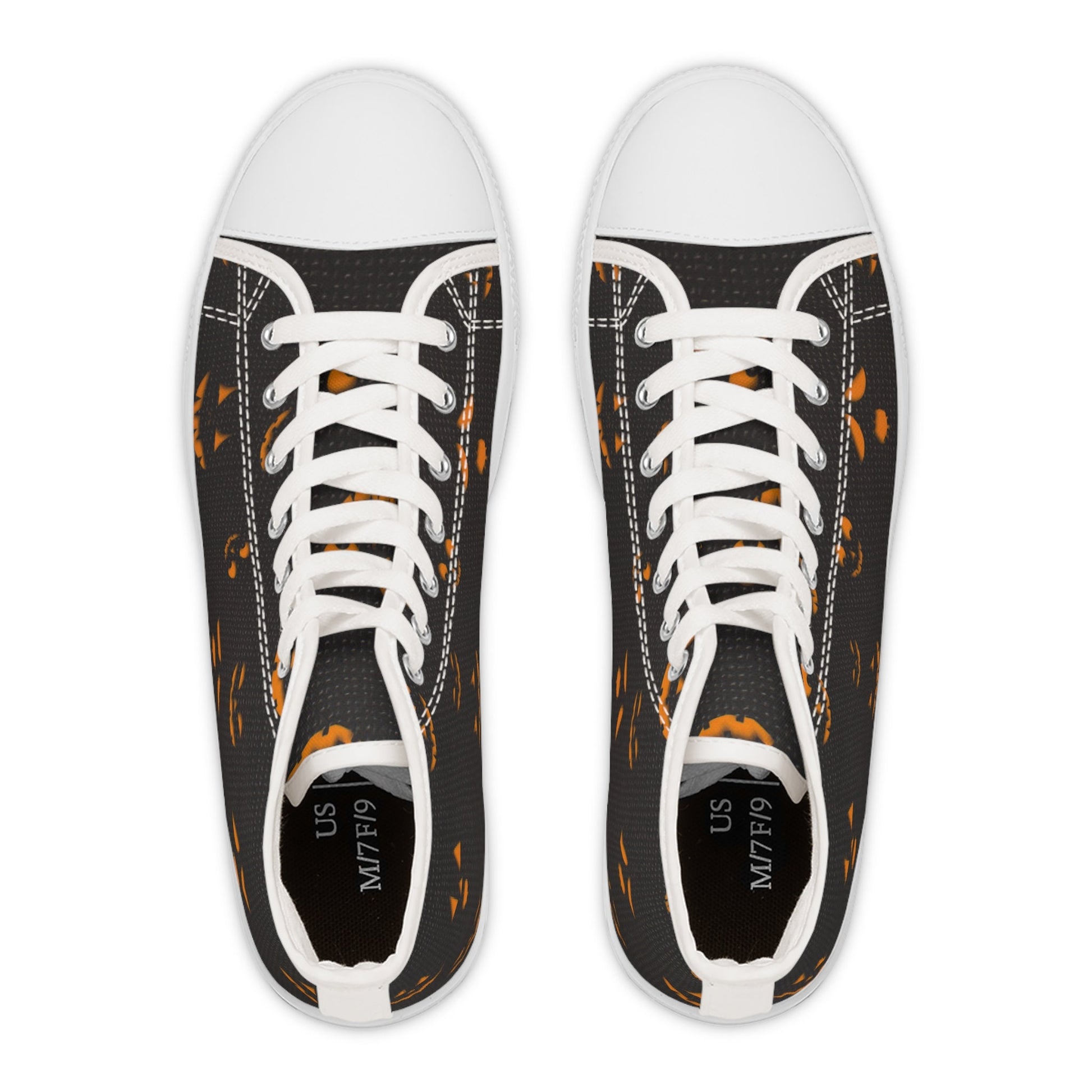 Top-down view of a pair of black high-top sneakers with white toe caps, laces, and soles. The shoes feature a festive Halloween pattern of glowing orange jack-o&#39;-lantern faces and have size labels inside indicating US M7/F9. Displayed on a plain white background.