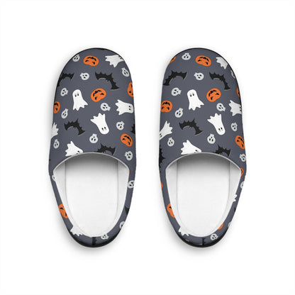 Top-down view of a pair of Halloween-themed slippers on a white background. The slippers feature a dark gray base with a fun pattern of white ghosts, black bats, orange jack-o&#39;-lanterns, and small skulls. The interior lining is white, creating a cozy and festive look.