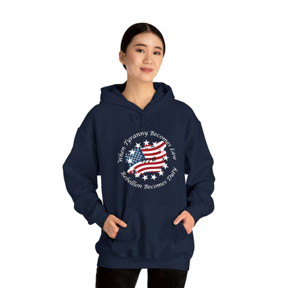 Navy Blue unisex hoodie with distressed American flag and “When Tyranny Becomes Law, Rebellion Becomes Duty” quote, modeled by woman on white background. 1776 patriotic pullover sweatshirt for men and women, bold conservative statement apparel, pro-freedom American hoodie. Ideal for political expression, USA pride, or patriotic gift ideas.