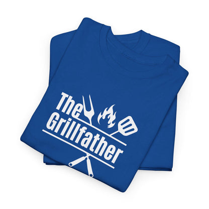 Folded royal blue T-shirt with the phrase “The Grillfather” in bold white text, featuring grilling icons of a fork, flame, and spatula above crossed utensils, displayed on a plain background.