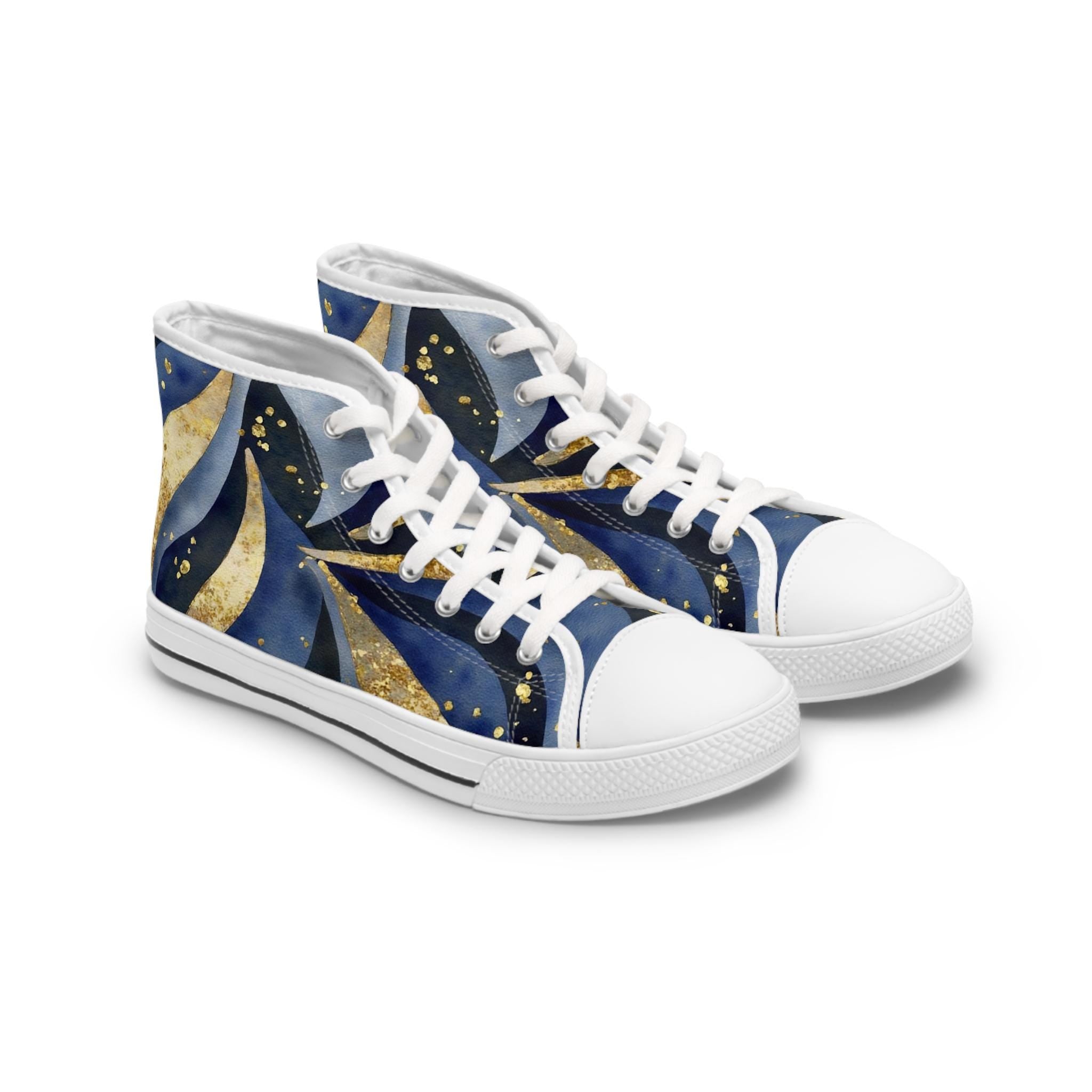 Pair of high-top canvas sneakers featuring a bold abstract design in navy blue, gold, and black with swirling patterns and dotted accents. The shoes have white rubber soles, white laces, and metal eyelets, displayed on a clean white background.