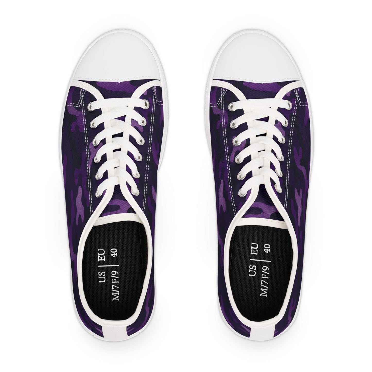 Top view of a pair of low-top canvas sneakers with a purple camouflage pattern, white rubber toe caps, and white laces. The insoles are black and printed with size details showing US M7/F9 and EU 40.