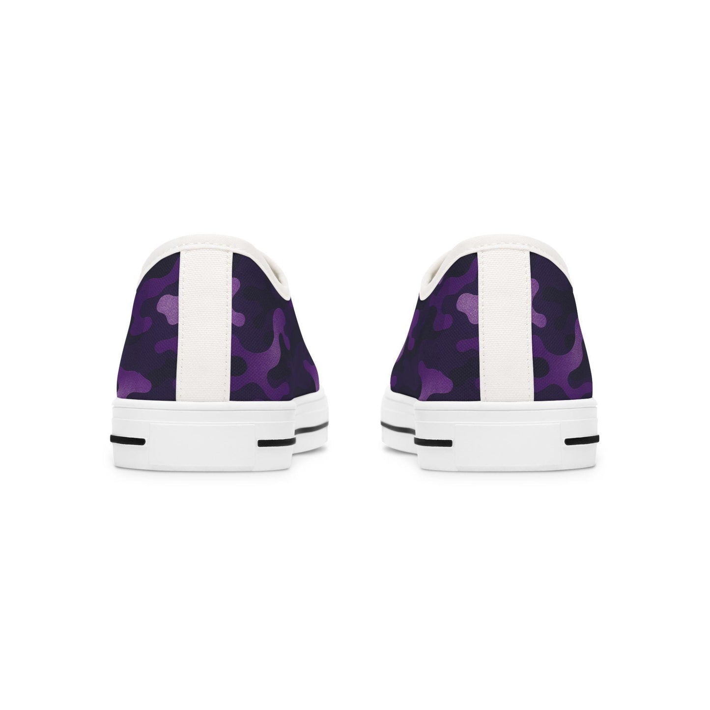 Rear view of a pair of low-top canvas sneakers featuring a purple camouflage pattern with white heel tabs and white rubber soles. The soles include black stripe accents near the back for added detail.