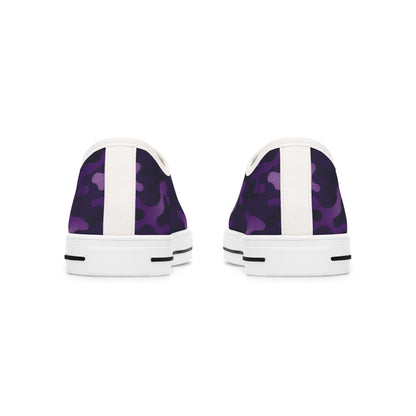 Rear view of a pair of low-top canvas sneakers featuring a purple camouflage pattern with white heel tabs and white rubber soles. The soles include black stripe accents near the back for added detail.