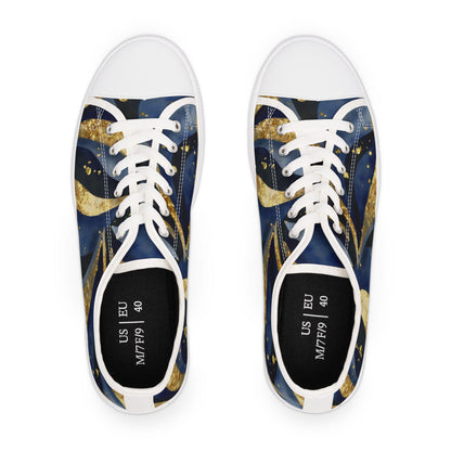 Top-down view of a pair of low-top canvas sneakers with a celestial-themed design in deep blue and gold tones, featuring swirling comet-like patterns. The shoes have white laces, white toe caps, and white soles. The insoles display size information: US M7/F9 and EU 40. The background is plain white, emphasizing the vibrant design and size markings inside the shoes.
