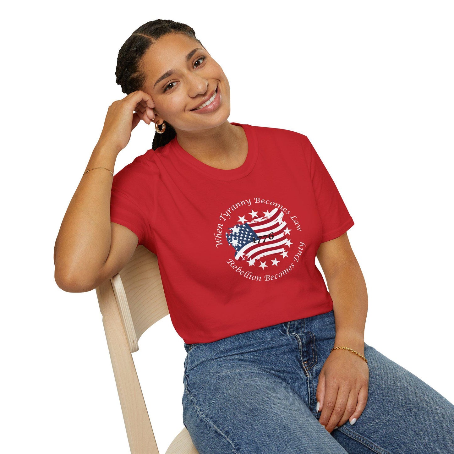 Smiling woman wearing a red patriotic graphic t-shirt with a distressed American flag and the quote &quot;When Tyranny Becomes Law, Rebellion Becomes Duty&quot;—casual freedom-inspired outfit paired with high-waisted jeans.