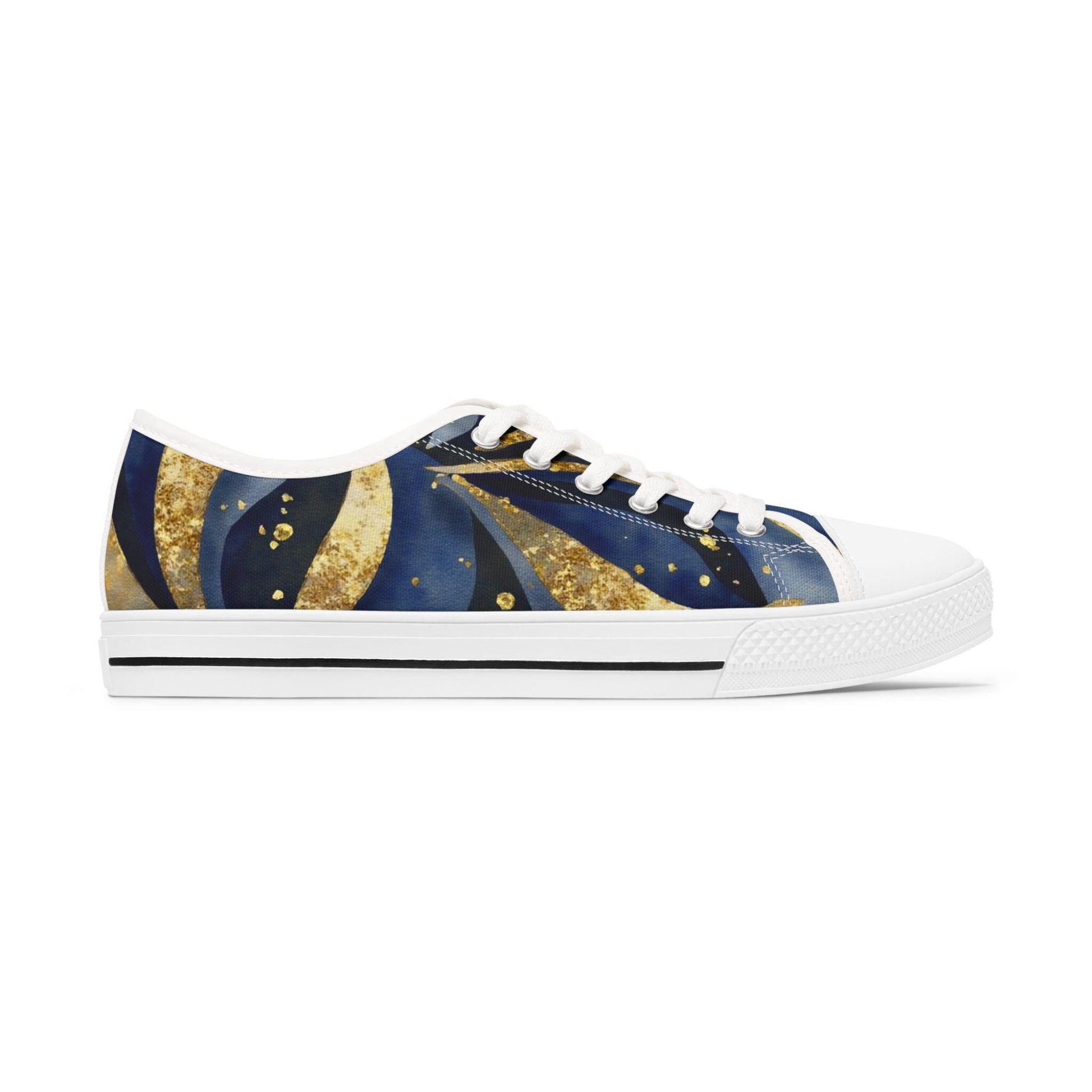 A side view of a stylish low-top canvas sneaker with a celestial-themed design in deep blue, gold, and black tones. The shoe features swirling patterns that resemble stars and cosmic waves, accented with gold speckles. It has a white rubber sole, white toe cap, white laces, and a thin black stripe along the midsole. The background is plain white, emphasizing the shoe&#39;s artistic and eye-catching design.