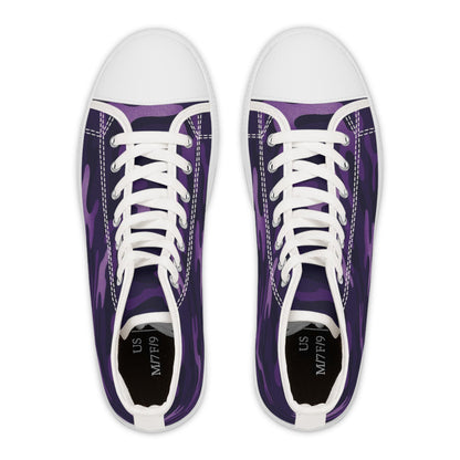 Top-down view of a pair of high-top sneakers featuring a purple camouflage pattern. The shoes have white rubber toe caps, white laces, and visible white stitching along the edges. The insoles are black with sizing information printed in white, indicating &quot;US M7/F9&quot;. The design presents a bold, modern look with classic sneaker elements.