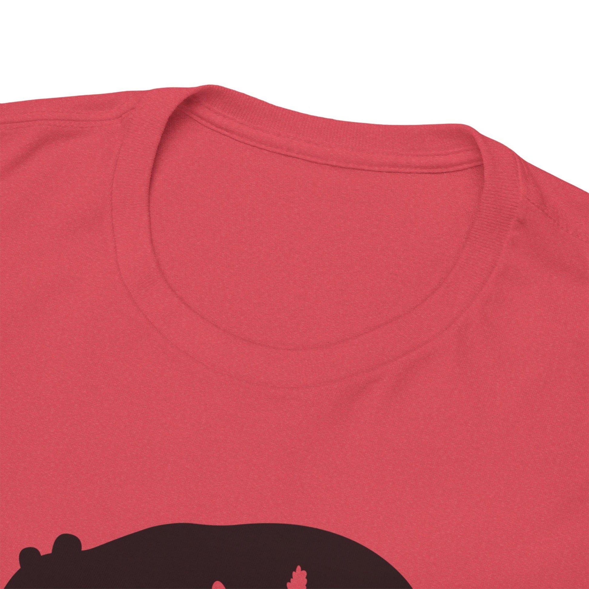 Close-up view of the neckline and upper chest area of a red t-shirt featuring a partial black graphic design. The image highlights the round crew neck collar, double-stitched seams, and soft fabric texture.
