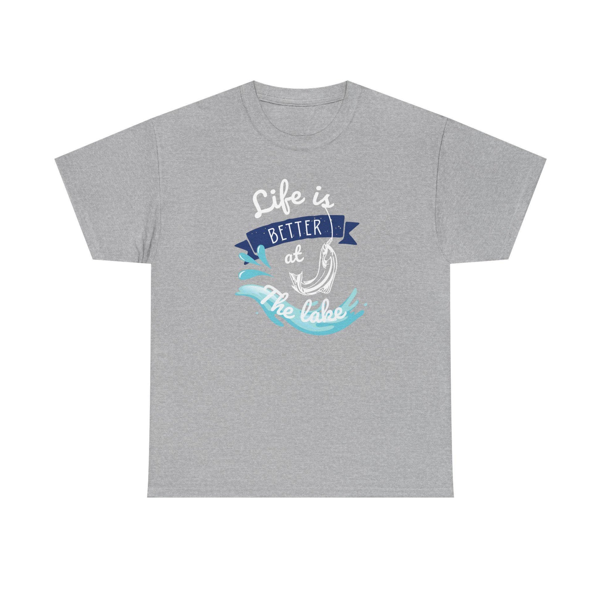 Flat lay of a heather gray unisex t-shirt featuring a colorful graphic that reads &#39;Life is Better at the Lake.&#39; The design includes a fish hook, water splash elements, and a navy blue banner, using white, blue, and aqua tones, displayed on a plain white background.