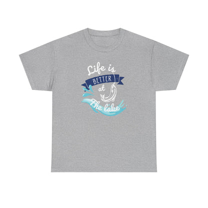 Flat lay of a heather gray unisex t-shirt featuring a colorful graphic that reads &#39;Life is Better at the Lake.&#39; The design includes a fish hook, water splash elements, and a navy blue banner, using white, blue, and aqua tones, displayed on a plain white background.