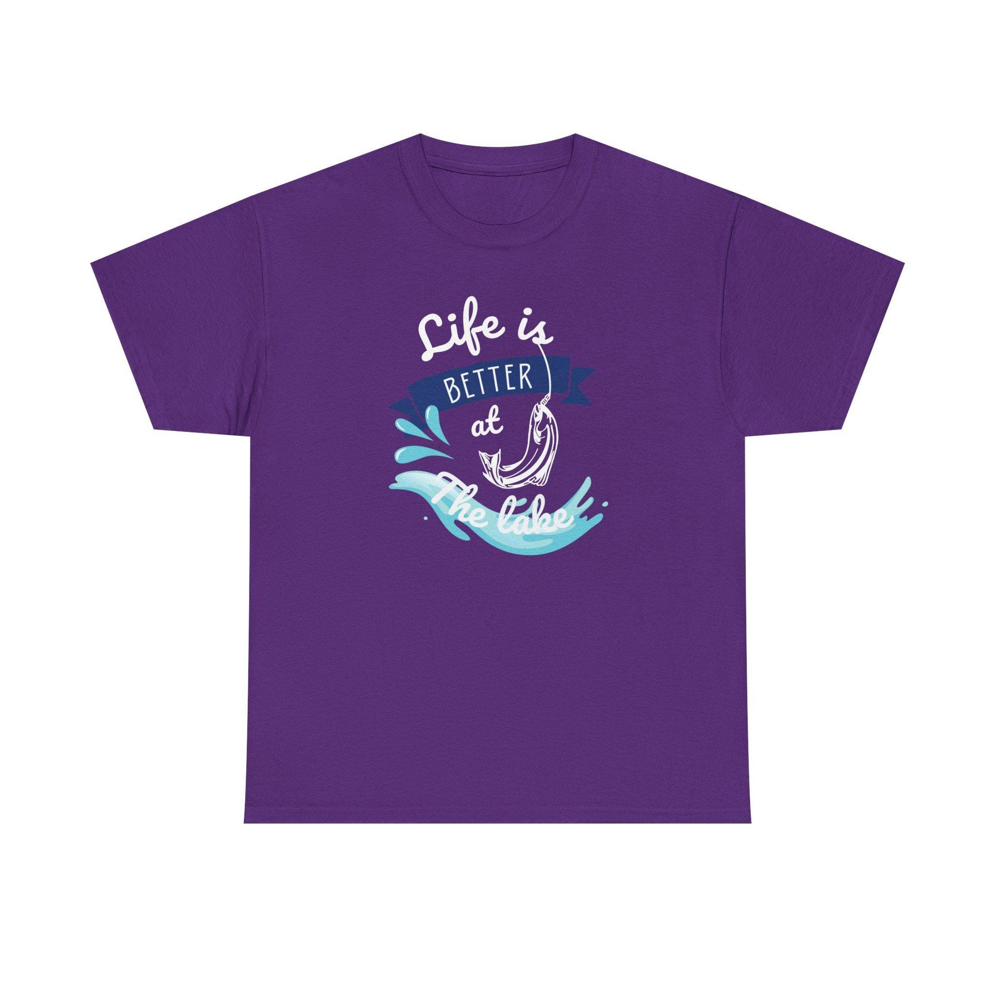 Flat lay of a purple unisex t-shirt featuring a graphic design with the phrase &#39;Life is Better at the Lake.&#39; The design includes a fish hook, water splash elements, and a navy blue banner, printed in white, blue, and aqua tones, on a plain white background.