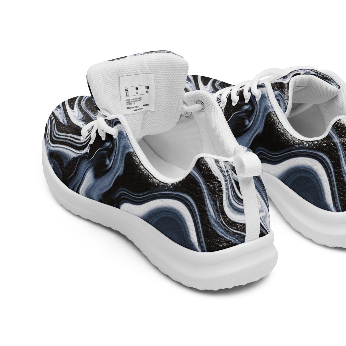Close-up rear view of women&#39;s athletic sneakers featuring a black, white, and gray abstract swirl pattern with white soles and laces. Visible interior size tag and padded collar highlight the comfortable design—ideal for showcasing stylish activewear shoes perfect for everyday wear, workouts, and walking.