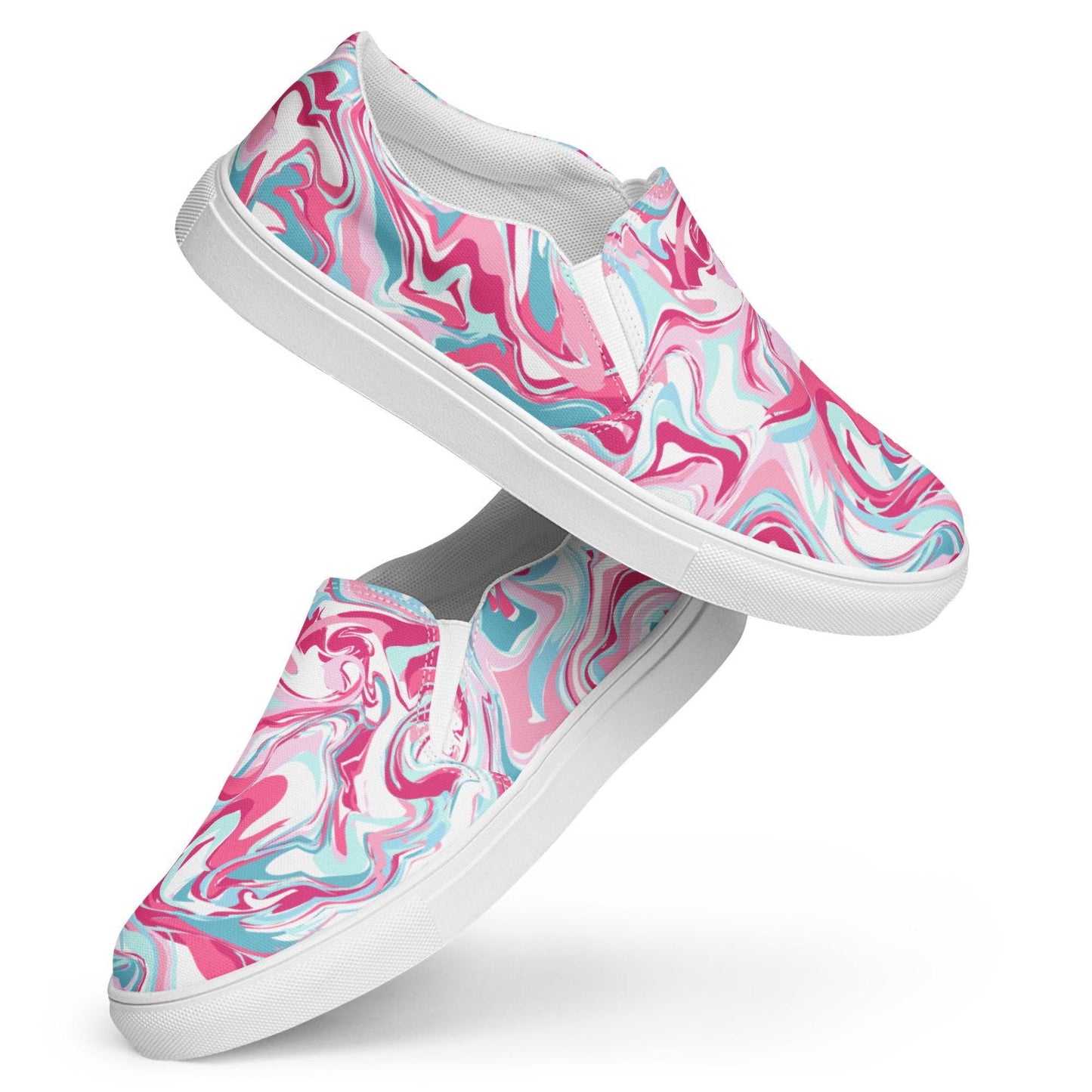 A pair of stylish slip-on sneakers with a vibrant marbled swirl design in shades of pink, teal, and white. The shoes are displayed against a clean white background, with one shoe propped diagonally on top of the other to showcase the pattern and side profile.