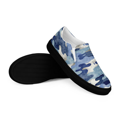 Women’s slip-on canvas shoes with blue camo print and black rubber soles, lightweight casual sneakers shown with side and sole view.