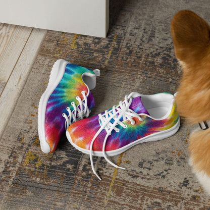 Pair of rainbow tie-dye sneakers with white soles and laces placed on a stylish rug near a curious dog—vibrant, comfortable footwear perfect for pet-friendly, casual lifestyles.