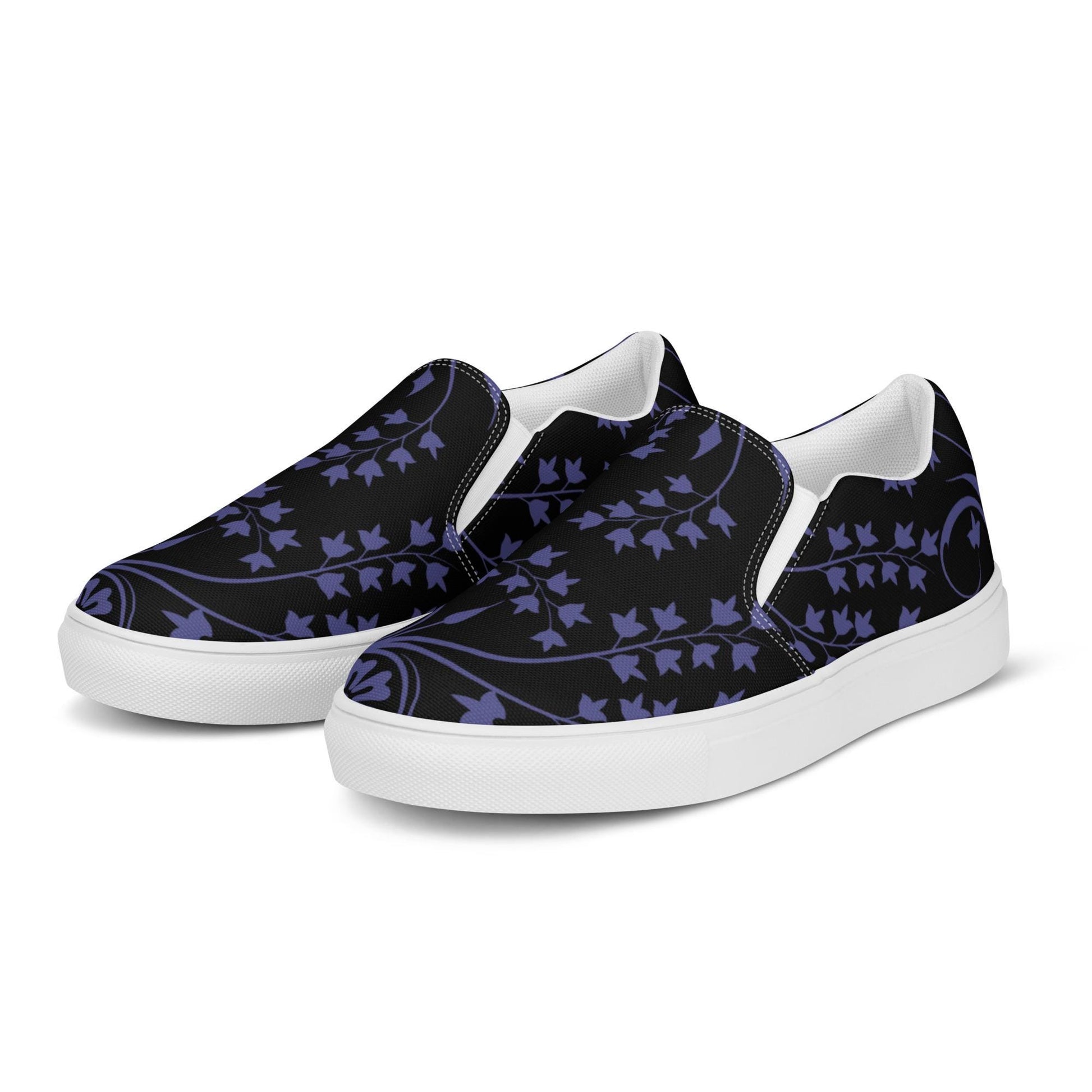 Pair of slip-on sneakers with a black canvas upper featuring a deep purple ivy vine pattern. The shoes have white soles, elastic side accents for easy wear, and a clean, minimal design ideal for casual and stylish everyday outfits.