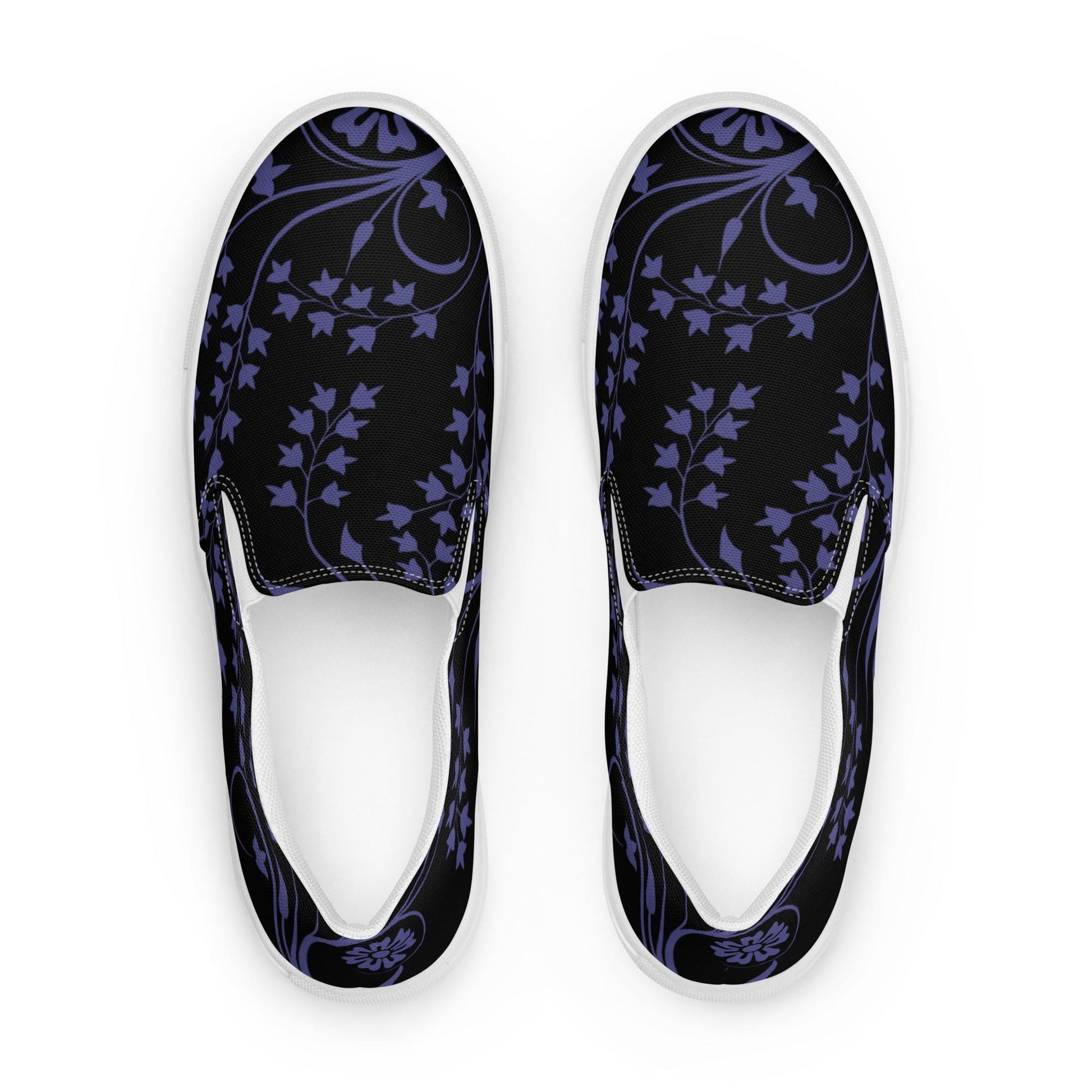 Top-down view of slip-on sneakers featuring a black canvas base with a deep purple floral and ivy vine pattern. The design includes curved vine accents and stylized blossoms, complemented by white inner lining and soles for a clean, modern contrast.