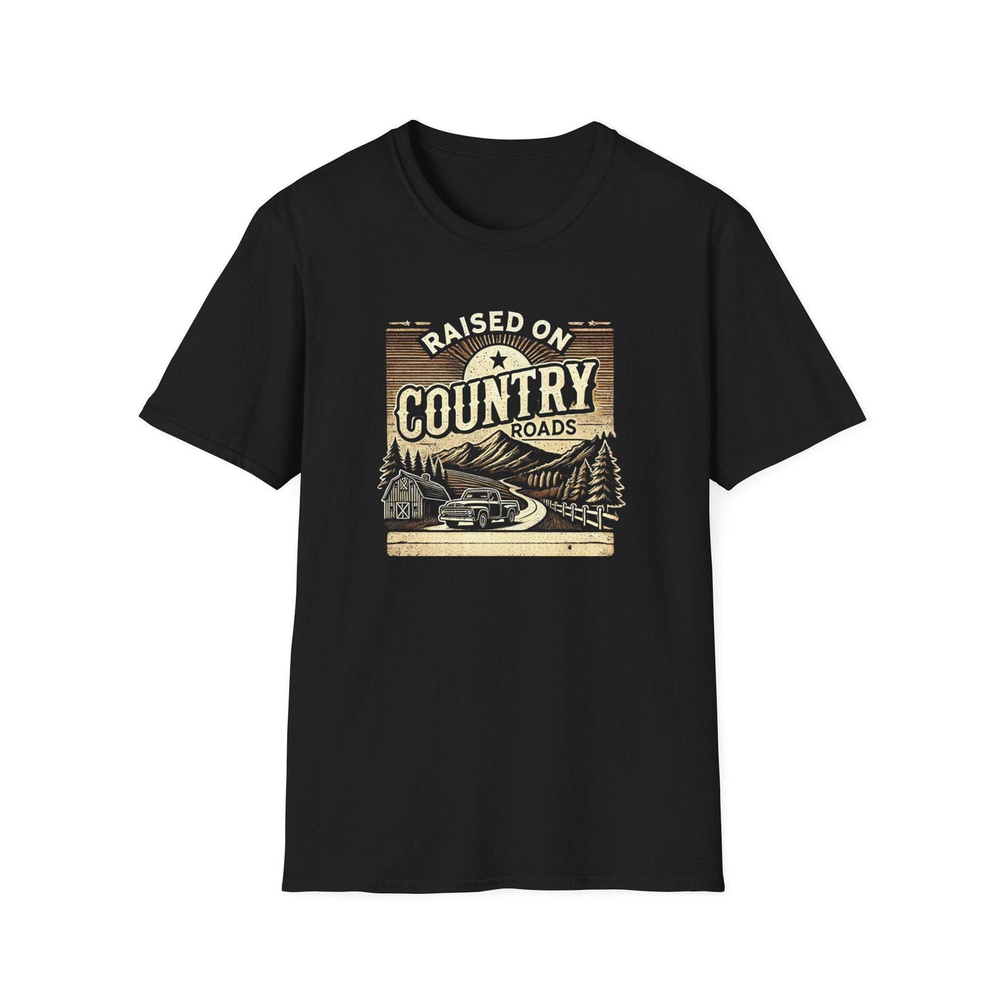 A black unisex t-shirt laid flat against a white background, featuring a vintage-inspired graphic that reads &quot;Raised on Country Roads.&quot; The design includes an old pickup truck driving along a winding road through a rural scene with pine trees, a barn, mountains, and a rising sun. The artwork has a rustic, retro feel with muted tan and brown tones.