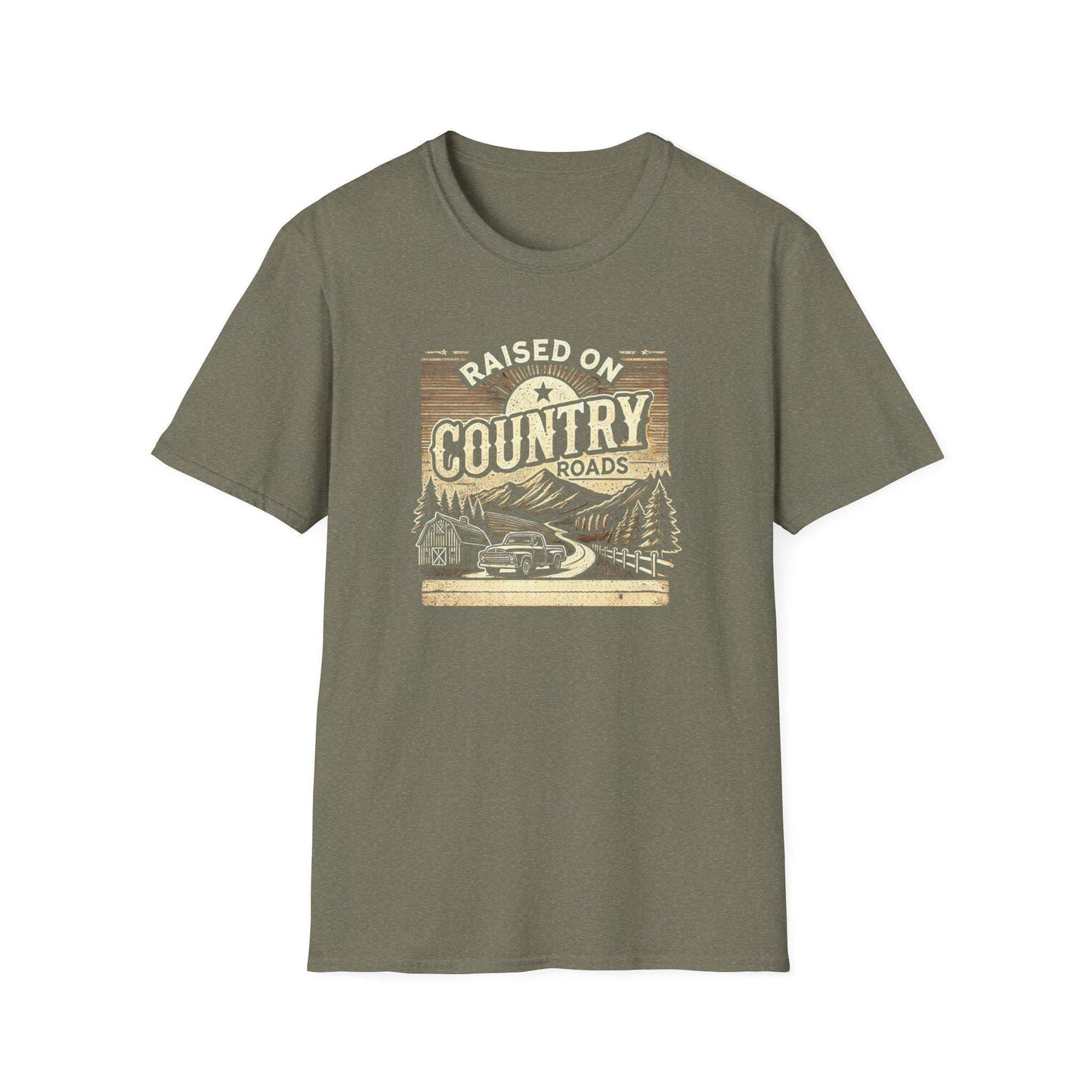 An olive green unisex t-shirt displayed flat on a white background, featuring a rustic graphic that reads &quot;Raised on Country Roads.&quot; The vintage-style design showcases a countryside scene with a classic pickup truck driving along a winding road past a barn, pine trees, and mountains, all under a rising sun. The artwork uses earthy tones and retro shading to evoke a nostalgic, rural Americana vibe.