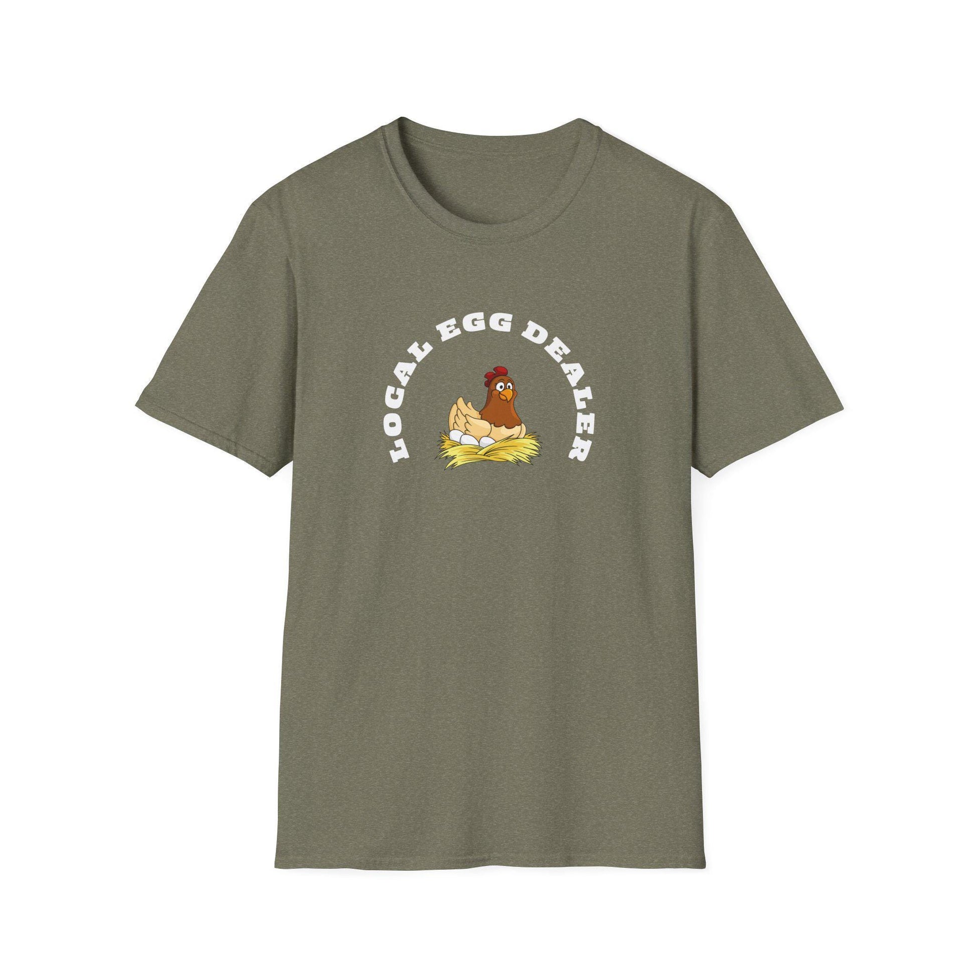 Olive green unisex t-shirt with a fun graphic of a cartoon hen sitting on a nest of eggs. The design features the phrase “LOCAL EGG DEALER” in bold white curved text above the illustration. The shirt is laid flat on a white background, highlighting its casual fit and crew neck style.