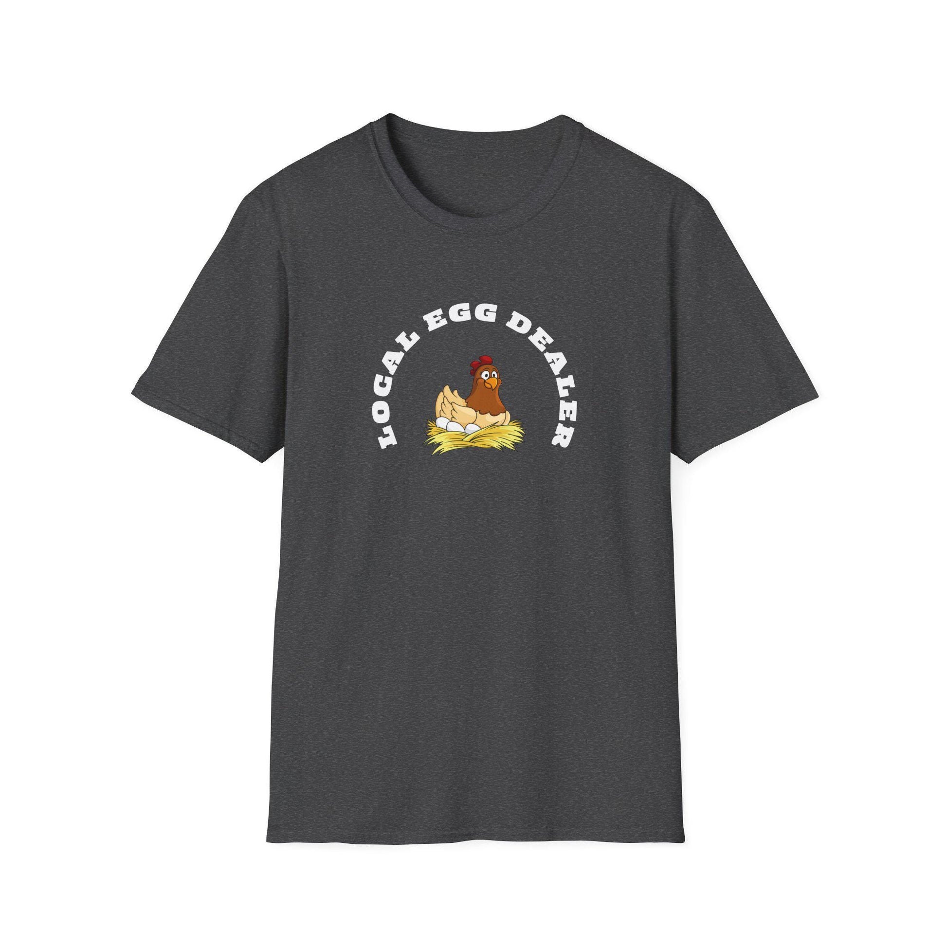 Charcoal heather unisex t-shirt featuring a fun and quirky graphic of a cartoon hen sitting on a nest of eggs. The phrase “LOCAL EGG DEALER” is printed in bold white curved text above the illustration. The shirt is laid flat on a white background, showing off its soft texture, classic fit, and crew neckline.