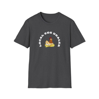 Charcoal heather unisex t-shirt featuring a fun and quirky graphic of a cartoon hen sitting on a nest of eggs. The phrase “LOCAL EGG DEALER” is printed in bold white curved text above the illustration. The shirt is laid flat on a white background, showing off its soft texture, classic fit, and crew neckline.