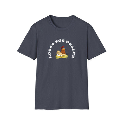 Heather navy unisex t-shirt featuring a whimsical design of a cartoon hen sitting on a nest of eggs. Above the illustration, bold white text reads “LOCAL EGG DEALER” in a curved arch. The shirt is displayed flat on a white background, showcasing its casual crew neck style.
